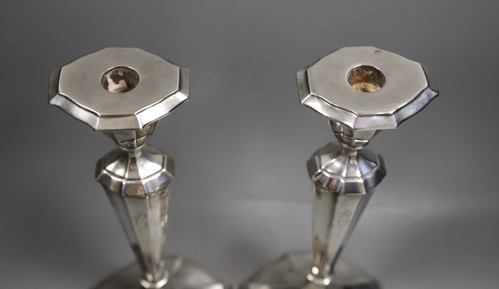 A pair of North American sterling candlesticks, with panelled stems and shaped oval bases, 34.1cm, weighted.